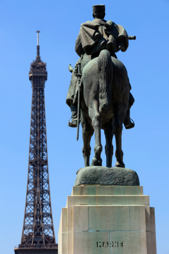 Paris, France - June 7, 2013: equestrian statue of Joseph Jacques Cesaire Joffre (1851-1932), a French general during World War I who defeated the Germans at the First Battle of the Marne, with the Eiffel Tower in the background. This 1939 monument by artist Maxime Real del Sarte monument is located in front of the acole Militaire on the Champs de Mars