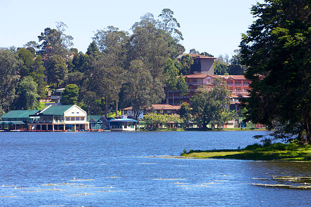 Kodaikanal, India - November 15, 2011:  The Kodaikanal Lake in the Palani Hills, in the South Indian State of Tamil Nadu situated at about 7000 feet above sea level; to the left is the boathouse on the lake, and to the right, the Carlton Hotel.