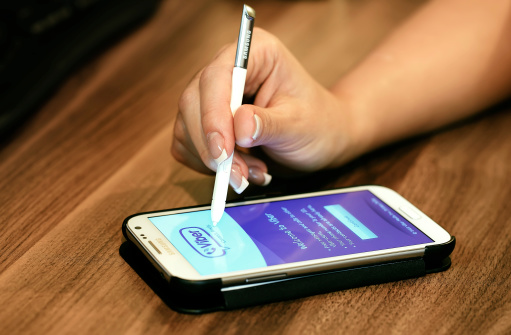 Istanbul, Turkiye - December 9, 2012:  Shot of woman's hand holding Samsung Galaxy SIII pen. The telephone is supported with 4.8