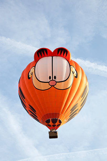 hot air ballon with wicker basket isolated on light blue and white with much copy space