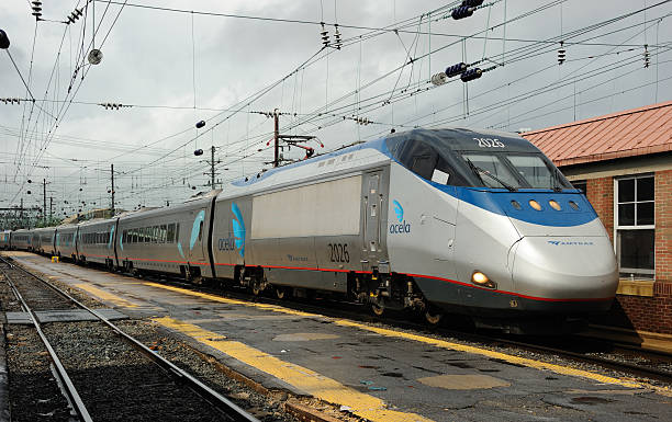 Acela Express at Washington Washington, United States - June 10, 2013: An Amtrak Acela Express arrives at Washington Union station after a six and a half hour journey from Boston, Massachusetts. This service, running at speeds of up to 150 mph, serves Boston - New Haven - New York - Philadelphia - Baltimore - Washington, DC as well as other cities in the Northeast Corridor. The leading unit, 2026, is part of a trainset consisting of two power cars and six passenger cars. Electric power is collected from overhead catenary by pantographs and supplied at 25 kV/60 Hz. Amtrak stock pictures, royalty-free photos & images