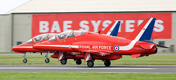 BAE Systems Hawk Red Arrows Fairford, Gloucestershire, United Kingdom - July 7th, 2012: A pair of Hawk Aircraft of the Royal Air Force aerobatic display team - The Red Arrow roll down the runway at the Royal International Air Tattoo (RIAT) british aerospace stock pictures, royalty-free photos & images