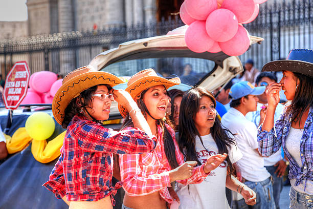 Arequipa, Peru - May 25, 2013: Animal rights protesters gather in the street in front of Arequipa Cathedral in the Plaza De Armas, Peru. Attractive teenage girls dressed as cowboys