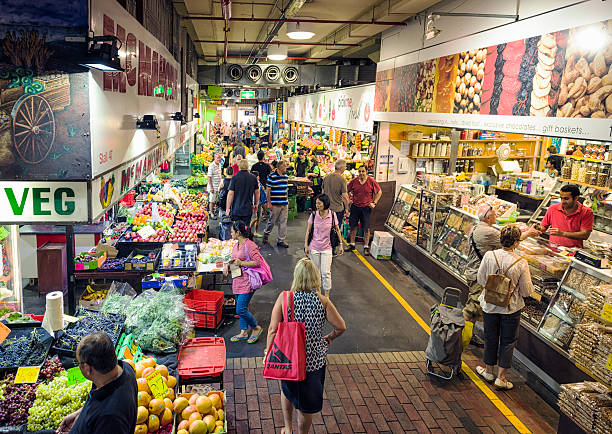 Adelaide, Australia - February 16, 2013: Customers and shopkeepers at various shop stalls in Adelaide Central Market.  The historic market has been an important part of the life of the city for over a century.
