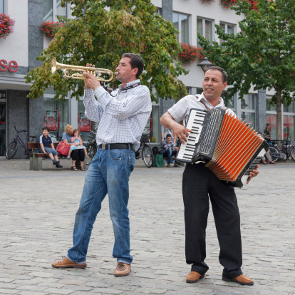 Soest, Germany - August 6, 2011 : Two male Street musicians making music on the Market square in the downtown area of Soest, Germany on a summer day in August, 2011.