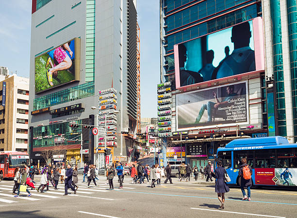 Busy Streets in Gangnam, Seoul Seoul, Republic of Korea - March 26, 2013: People crossing the street in the busy Gangnam district of the South Korean capital, with large advertising screens on the buildings. kangnamgu stock pictures, royalty-free photos & images
