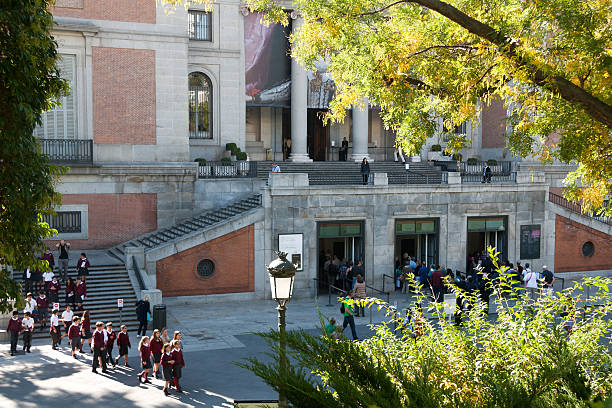 Madrid - The Prado Museum outside Madrid, Spain - October 18, 2013: Spanish schoolchildren and people wait in line at the Prado Museum ticket office. The Museum is the main Spanish national art museum, located in the central Retiro district. museo del prado stock pictures, royalty-free photos & images