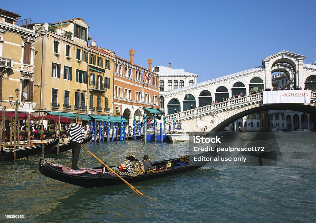 Gondola at Rialto bridge Venice, Italy - October 26, 2009: Gondola at Rialto Bridge on October 26, 2009 in Venice, Italy. There were several thousand gondolas in the 18th century, with only several hundred today for tourism. Ancient Stock Photo