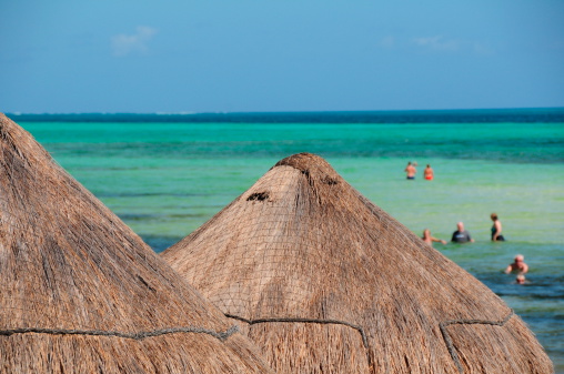 Cancun, Mexico- November 13, 2012: One of the many coastal resorts on the Yucatan peninsula where tourists can bathe safely on a shallow sandbar close to the resort.