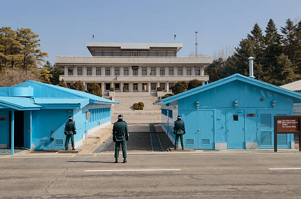 PANMUNJOM, NORTH KOREA - APRIL 2019: The view of Joint Security Area, including the House of Freedom and the blue meeting huts in the DMZ from the Phanmun Pavilion on the North Korean side of the border between North and South Korea.