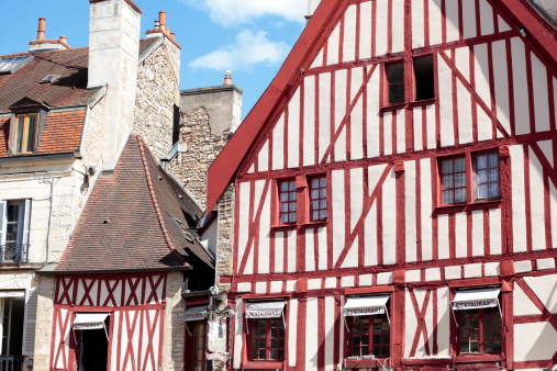 Dijon, France - September 9, 2013: Traditional half-timbered buildings situated in the historic center of Dijon, Burgundy, France.  The half-timbered style is typical of medieval buildings in France and Northern Europe.