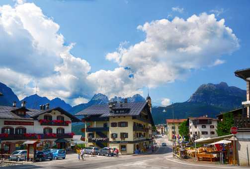 Sappada, Italy - July 20, 2013: Main street of Sappada. Well-known summer and winter in the Dolomites. On the way some people walk. Photo taken in a public area
