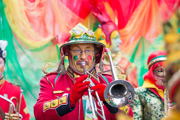 Musician marching in red costume at carnival parade of Maastricht stock photo