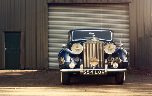 London, England, UK- November 11, 2012: Vintage Rolls-Royce Silver Wraith parked in front of a garage door