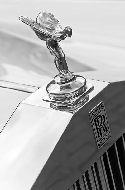 Spirit of Ecstasy Cracow, Poland - June 29, 2013: This black and white photo of the old english car Rolls Royce with the hood ornament 'Spirit of Ecstasy' was taken on the rally of vintage cars in Cracow, Poland. The ornament is in the form of a woman leaning forwards with her arms outstretched behind and above her. Billowing cloth runs from her arms to her back, resembling wings. rolls royce stock pictures, royalty-free photos & images