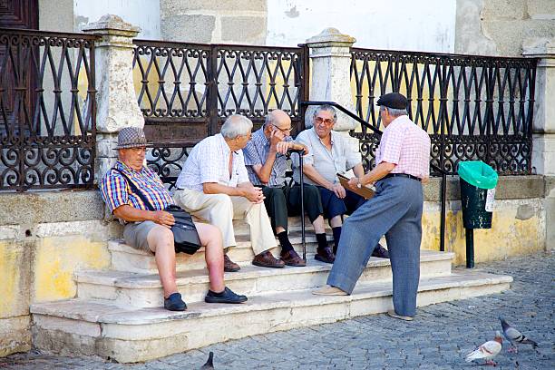 Elderly men socialising at the town square stock photo