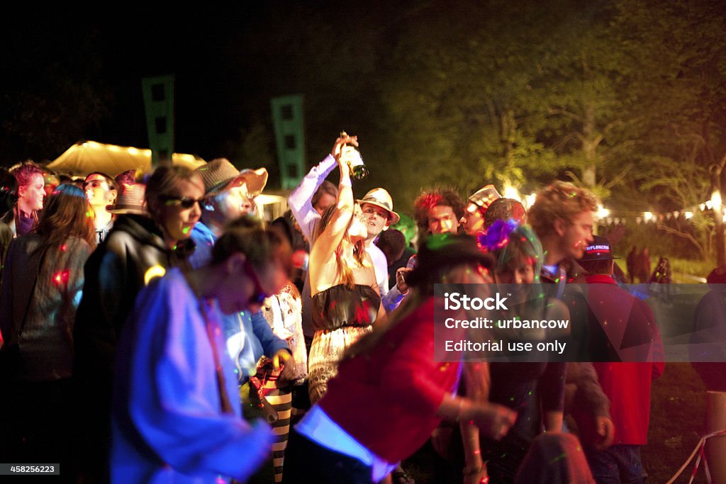 Enjoying a live music event Musbury, UK - June 8, 2013: Festival attendees dance at a live music festival, Castlewood Wine Festival, Musbury, Devon Adult Stock Photo