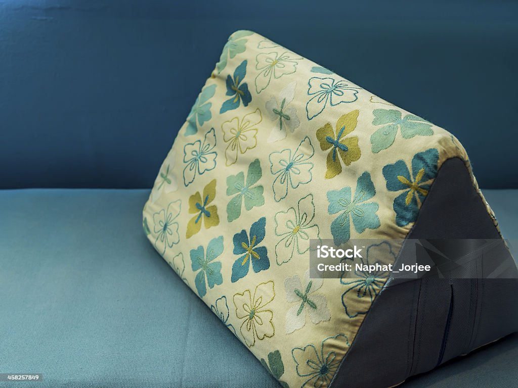 Triangular backrest pillow with colorful textile Triangular backrest pillow with colorful textile pattern Asia Stock Photo