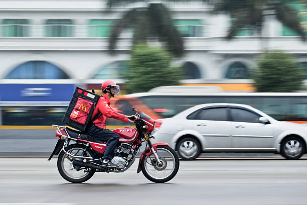 Guangzhou, China &ndash; February 22, 2012: McDonald food delivery on a motorcycle. It took McDonald 19 years to reach 1,000 restaurants in China and the company plans to double the number of its Chinese outlets to 2,000 by 2013.