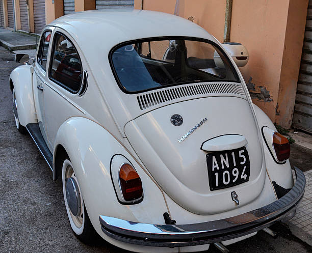 Ancona, Italy - January 06, 2013: Old white Volkswagen Beetle parked in the street, posterior and side view. In 1975, the arrow keys are moved to the front bumper and the side of the counter. The production of the 1303 model sedan will cease, while the 1303 convertible will remain on the market until 1980.