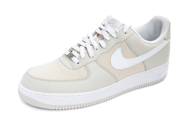 Nike Air Force 1 Shoe Taipei, Taiwan - December 18, 2012: This is a studio shot of a cream colored Air Force 1 sneaker made by Nike isolated on a white background. nike air photos stock pictures, royalty-free photos & images