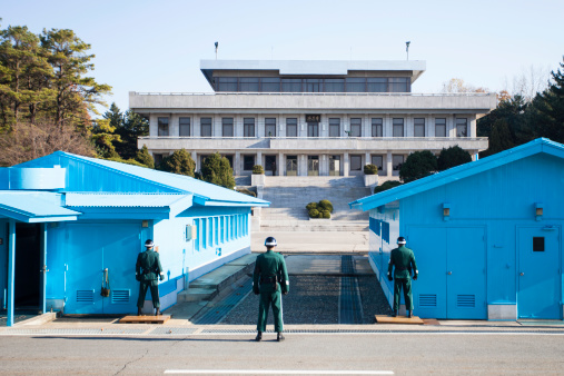 Panmunjom, Republic of Korea - November 14, 2012: South Korean Soldiers guard the border between South and North marked by a short concrete wall. Joint Security Area (JSA) is the only portion of the Korean Demilitarized Zone (DMZ) where South and North Korean forces stand face-to-face. It is often called the \