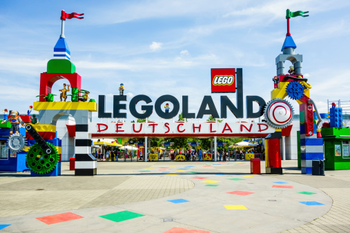GAnzburg, Germany - August 15, 2013: A Legoland Deutschland entrance sign at LEGO Deutschland Resort in GAnzburg, Germany. It was opened on spring 2002 as the 4th Legoland worldwide, owned by Merlin Entertainments Group from 2005.