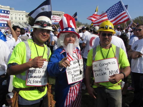 Washington D.C., USA-April 10, 2013:  Latino protesters rally in front of the U.S. Capitol building in Washington D.C. in order to reform immigration laws in the United States.  Barack Obama was elected with the Latino vote and promised immigration reform.