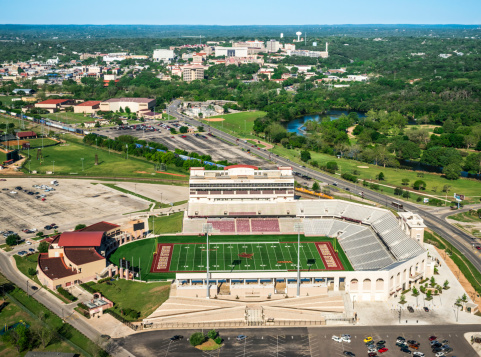 San Marcos, Texas, USA - April 19, 2013: Texas State University Football Stadium, with city of San Marcos visible in background. Aerial View from helicopter in morning.