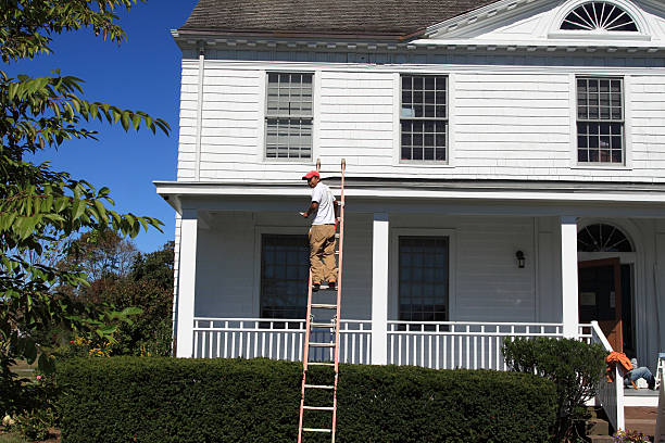 Stamford, CT, USA - September 23, 2013: A man is painting one the structures on a beautiful summer day at the city \