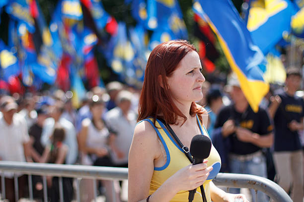 Journalist making report with protestors of "Rise up, Ukraine!" stock photo