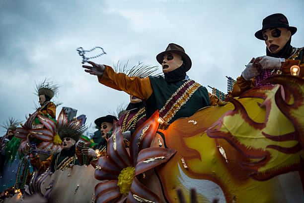 New Orleans, LA, USA - February 9, 2013: A costumed man throws beads toward the crowd during a Mardi Gras parade on Canal Street in New Orleans, Louisiana