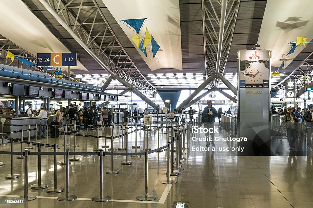 Kansai International Airport Osaka, Japan - March 25th 2012: Kansai International Airport. People walking inside the Terminal 1 on the 4th floor while other people are doing the check in on the north part of the airport. This floor is for international departures. Airport Stock Photo