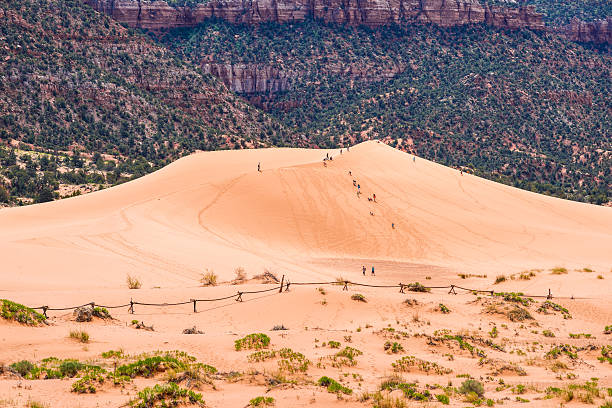 Pink Sand Dunes, Utah, USA - May 21st, 2013: Kids and adults are climbing one of the dunes in Coral Pink Sand Dunes State Park in Utah, USA.