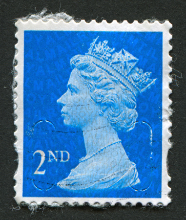 Gomel, Belarus - March 24, 2013: Postage stamp. A stamp printed in UK shows image of Elizabeth II is the constitutional monarch of 16 sovereign states known as the Commonwealth realms, in blue, circa 1989.