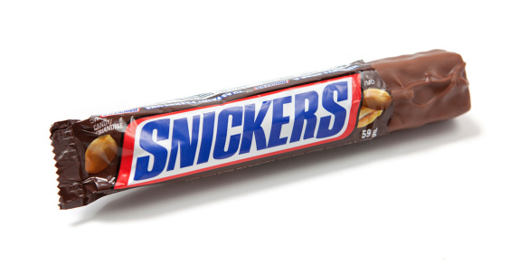 Toronto, Canada - May 10, 2012: This is a studio shot of a Snickers candy bar made by Mars, Incorporated isolated on a white background.