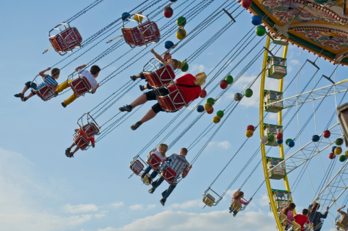 Herne, Germany - August 12th 2012: Kids, Couples and Families enjoy a ride on the carousel at the famous fun fair \