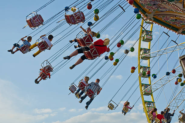 Children and Parents enjoy riding a Chairoplane at the Fair stock photo