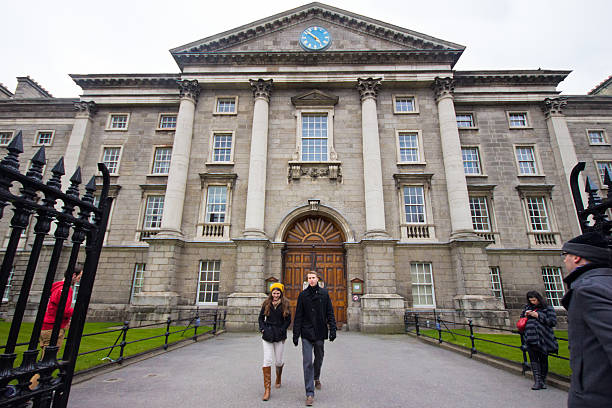 Trinity College Dublin, Ireland - April 1, 2013: Students and exterior view Trinity College in Dublin Ireland on April 1, 2013.  The college was founded in 1592 as the "mother" of a new university and is located in Dublin's College Green. trinity college library stock pictures, royalty-free photos & images