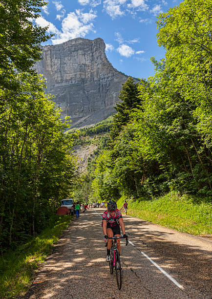 Amateur Female Cyclist La Palud,France-July 13th, 2012: Amateur female cyclist climbing the road to mountain pass Granier before the passing of the peloton during the stage 12th of La Tour de France 2012. tour de france stock pictures, royalty-free photos & images