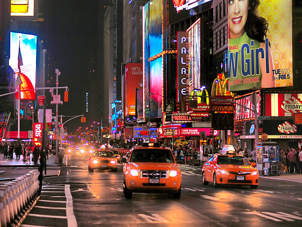 New York New York, United States - August 29, 2011: Unusually small crowd of people and cars, taxis, on Times Square in New York on rainy day after hurricane Irena. In background there are NY skyscrapers with lot of commercial and lights. irene car a stock pictures, royalty-free photos & images
