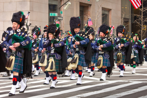 New York City, NY, USA - March 16, 2013:   Parade participants in traditional dress march up Fifth Avenue in New York City with bagpipes on March 16, 2013 in the 252nd Annual NYC St. Patrick's Day Parade.  The parade celebrating Irish heritage in NYC began in 1762 and today, is the largest and biggest St. Patrick's Day Parade in the world.