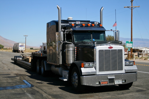 Bishop, USA - September 20, 2010: Huge black Peterbilt truck parked by the road in Death Valley area.