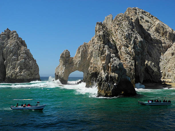 Boats at the Arch in Cabo San Lucas stock photo