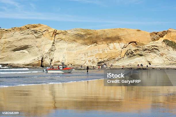 Dory Boat Returning Sandstone Cliff Cape Kiwanda Pacific City Oregon Stock Photo - Download Image Now