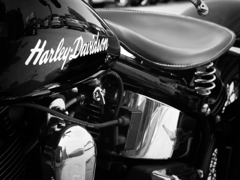Padua, Italy - May 12, 2012: Harley-Davidson brand name on a motorcycle gas tank. Harley-Davidson Harley-Davidson, also known as H-D or Harley, is an American motorcycle manufacturer founded in Milwaukee during the early 1900. H-D sells heavyweight motorcycles well known all over the world, for their distinctive design and exhaust note. Shot in a public parking.