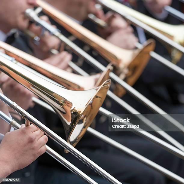 Musicians Playing Trombones In Orchestra At Outdoor Concert Square Closeup Stock Photo - Download Image Now