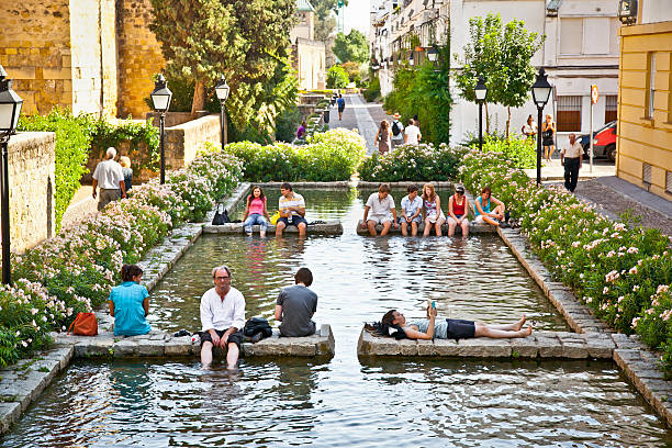 Cordoba, Spain- September 13, 2011: Unidentified people relaxing in fountain on Sep 13. 2011. in Cordoba, Spain . Due to extremely hot summer temperatures people are seeking alternative ways to cool themselves.