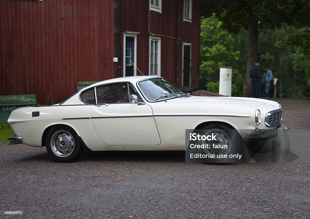 Volvo P1800 from 1967 Uppsala, Sweden - July 17, 2012: Car enthusiast driving an old sport car Volvo P1800 from 1967 sc in a classic car cavalcade on small public roads around the  town Uppsala in Sweden Volvo Stock Photo