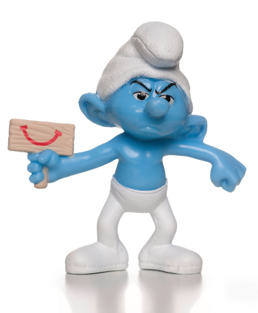 Miami, USA - August 06, 2013: Grouchy Smurf McDonalds happy meal toy. This is a plastic toy sold as part of the McDonald's Happy Meals.